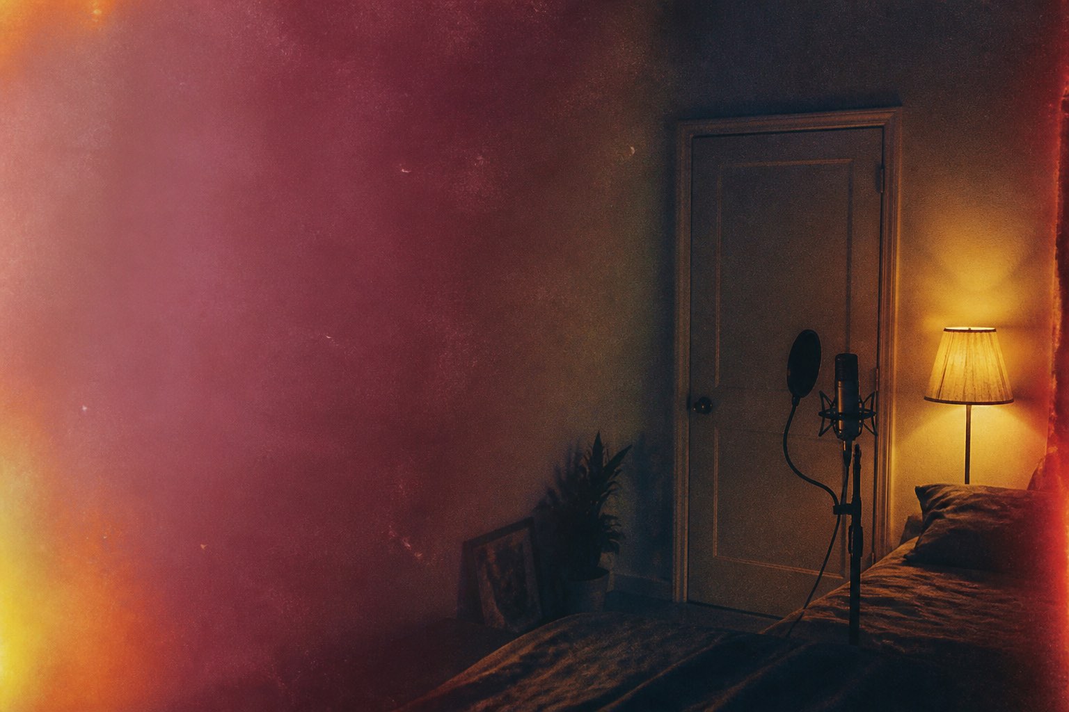 A room with the door closed, headphones and a microphone